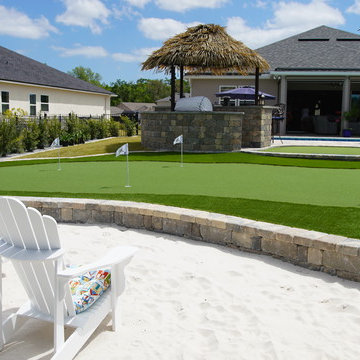 Back Yard Paradise: Paver, Fire-pit, Custom Golf course, Outdoor kitchen.