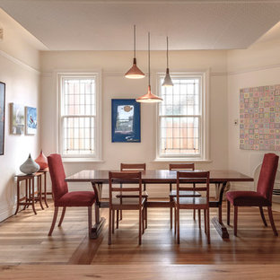 Photo of a transitional separate dining room in Hobart with beige walls, dark hardwood floors, a corner fireplace and brown floor.