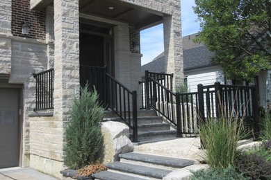 Example of a small transitional granite floor and white floor entryway design in Toronto with beige walls and a black front door