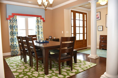 Example of a large classic dark wood floor and brown floor enclosed dining room design in Other with beige walls and no fireplace