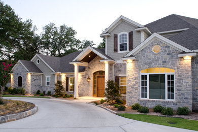 Large traditional gray two-story mixed siding exterior home idea in Austin with a hip roof