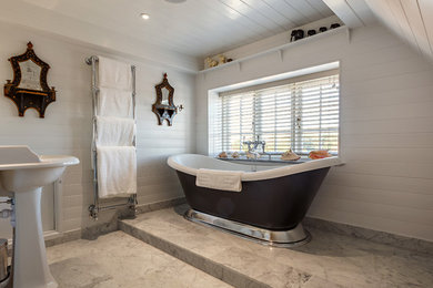 Small beach style master bathroom in Essex with a freestanding tub, white tile, subway tile, white walls, marble floors, a pedestal sink and grey floor.