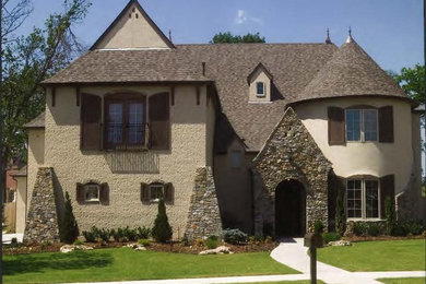 Example of a mid-sized mountain style beige two-story mixed siding gable roof design in Oklahoma City