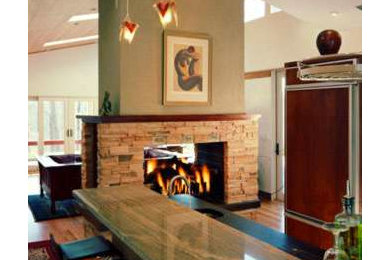 Large arts and crafts single-wall medium tone wood floor eat-in kitchen photo in Richmond with an undermount sink, flat-panel cabinets, dark wood cabinets, limestone countertops and paneled appliances