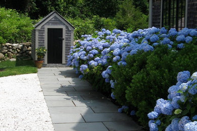 Large traditional side yard partial sun driveway in Boston with natural stone pavers for spring.