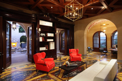 Living room library - large mediterranean open concept marble floor living room library idea in Los Angeles with beige walls