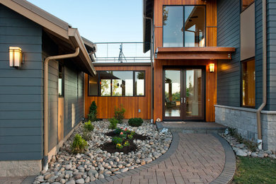 Example of a large trendy multicolored two-story mixed siding gable roof design in Other