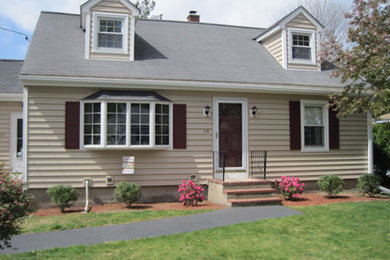 Example of a mid-sized beige two-story wood exterior home design in Boston