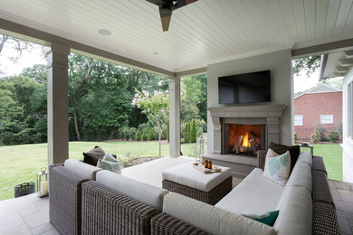 Inspiration for a large transitional backyard patio in Other with with fireplace, concrete pavers and a roof extension.