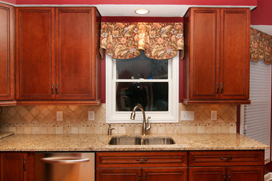 Inspiration for a mid-sized u-shaped dark wood floor eat-in kitchen remodel in Columbus with a double-bowl sink, recessed-panel cabinets, medium tone wood cabinets, granite countertops, beige backsplash, cement tile backsplash, stainless steel appliances and an island