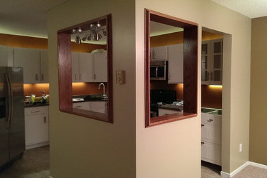 Eat-in kitchen - large contemporary l-shaped ceramic tile eat-in kitchen idea in Minneapolis with a drop-in sink, flat-panel cabinets, white cabinets, laminate countertops, brown backsplash, stainless steel appliances and no island