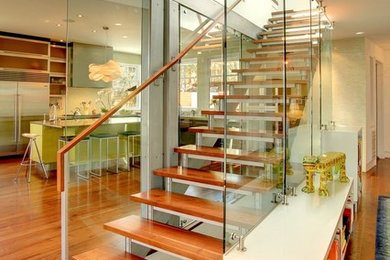This is an example of a contemporary wood straight staircase in Denver with open risers.