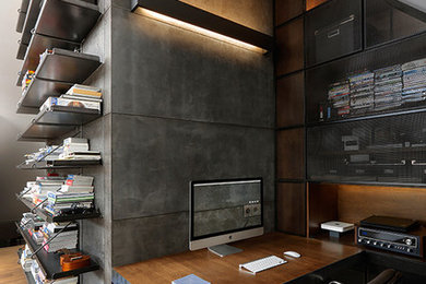 Study room - small industrial built-in desk medium tone wood floor study room idea in Valencia with gray walls