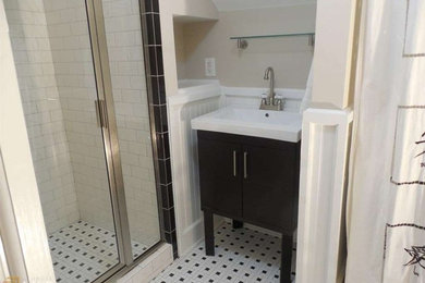 Alcove shower - mid-sized traditional kids' white tile and subway tile white floor alcove shower idea in Atlanta with furniture-like cabinets, black cabinets, a one-piece toilet, a hinged shower door and beige walls