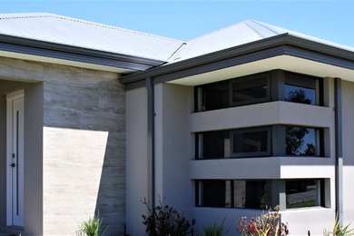Inspiration for a modern one-storey brown exterior in Perth with a metal roof.