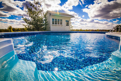 Inspiration for a large timeless backyard concrete hot tub remodel in Toronto
