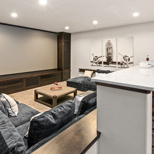Large farmhouse home cinema in Cincinnati with brown floors, grey walls and a built-in media unit.