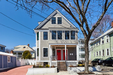 Example of a classic beige three-story duplex exterior design in Boston