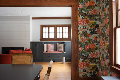 Mid-sized eclectic enclosed medium tone wood floor, brown floor and wallpaper living room photo in Minneapolis with gray walls, a standard fireplace, a shiplap fireplace and a concealed tv