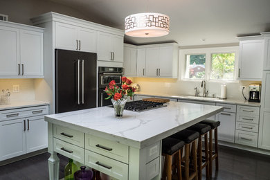 Inspiration for a mid-sized modern u-shaped medium tone wood floor eat-in kitchen remodel in Detroit with an undermount sink, flat-panel cabinets, white cabinets, quartz countertops, white backsplash, ceramic backsplash, black appliances and an island