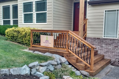 Inspiration for a small timeless front porch remodel in Portland with decking