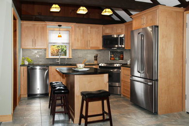 Inspiration for a small transitional u-shaped porcelain tile and multicolored floor open concept kitchen remodel in Boston with an undermount sink, shaker cabinets, light wood cabinets, soapstone countertops, gray backsplash, ceramic backsplash, stainless steel appliances, an island and black countertops