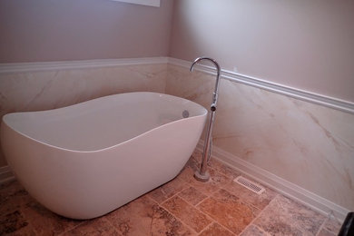 Example of a mid-sized trendy master white tile and stone slab limestone floor and beige floor bathroom design in Ottawa with gray walls