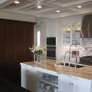 Large transitional kitchen pantry designs - Example of a large transitional u-shaped dark wood floor kitchen pantry design in Las Vegas with an undermount sink, shaker cabinets, white cabinets, marble countertops, white backsplash, stone slab backsplash, stainless steel appliances and two islands