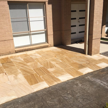 Larger sandstone pavers for the entrance. Pots were positioned around the edge.
