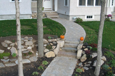 Design ideas for a mid-sized traditional partial sun front yard brick garden path in Providence.