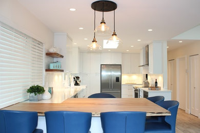 Contemporary kitchen in Vancouver with flat-panel cabinets, white cabinets and quartz benchtops.