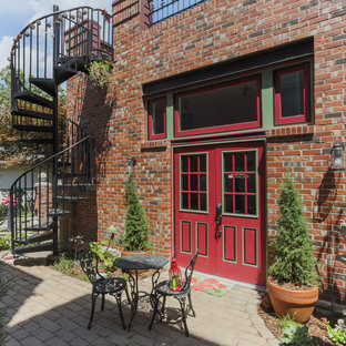 Mid-sized victorian backyard patio in St Louis with concrete pavers and no cover.