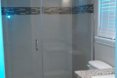 Mid-sized transitional ceramic tile ceramic tile alcove shower photo in Houston with shaker cabinets, white cabinets, a one-piece toilet, gray walls, an undermount sink and granite countertops