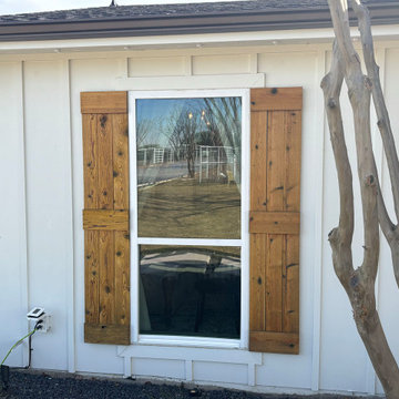 Wood Shutters on White Board and Batten With Window Trim
