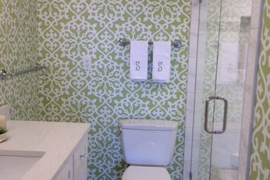 Example of a mid-sized classic 3/4 white tile and porcelain tile marble floor and white floor alcove shower design in Other with recessed-panel cabinets, white cabinets, a two-piece toilet, green walls, an undermount sink, quartz countertops and a hinged shower door