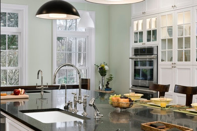 Mid-sized elegant u-shaped eat-in kitchen photo in Boston with a drop-in sink, white cabinets, green backsplash, an island, shaker cabinets, granite countertops and stainless steel appliances