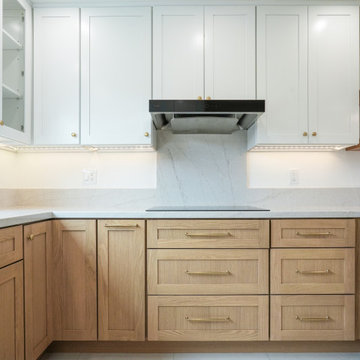Modern White and Natural Oak Kitchen with Brass Hardware and Quartz Backsplash
