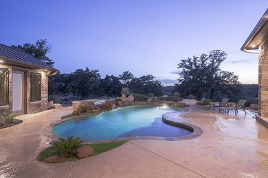 Inspiration for a mid-sized contemporary backyard custom-shaped hot tub remodel in Austin