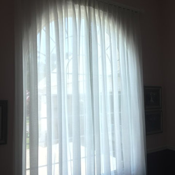 Pinch Pleat Sheer Drapery Panels over arch top window