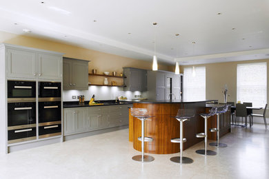 Inspiration for a contemporary kitchen/diner in Hampshire with shaker cabinets, grey cabinets, quartz worktops and an island.