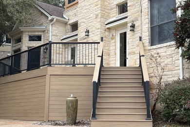 Mid-sized minimalist backyard mixed material railing deck skirting photo in Austin
