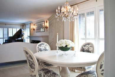 Inspiration for a small timeless light wood floor enclosed dining room remodel in Seattle with white walls