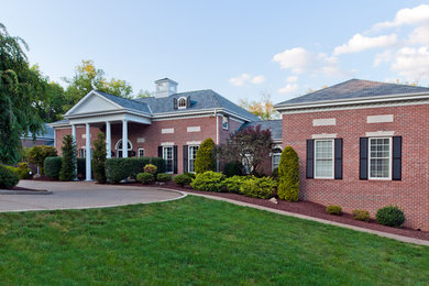 Large multicolored two-story brick exterior home idea in Other
