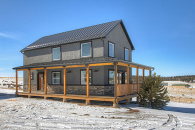 Large minimalist gray two-story stone house exterior photo in Denver with a clipped gable roof, a shingle roof and a gray roof