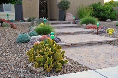 This is an example of a large contemporary front yard brick garden path in Phoenix.