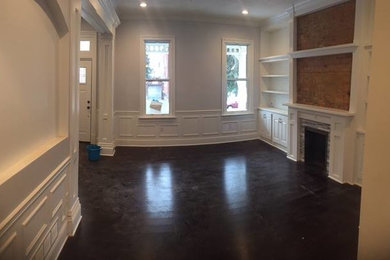 Minimalist bamboo floor living room photo in Other with gray walls, a standard fireplace, a tile fireplace and a media wall