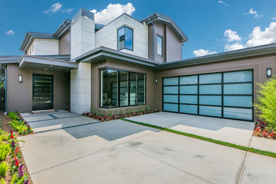 Inspiration for a large contemporary multicolored two-story mixed siding exterior home remodel in Los Angeles with a tile roof