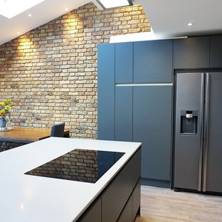 Mid-sized contemporary kitchen pantry inspiration - Mid-sized trendy u-shaped kitchen pantry photo in Hertfordshire with gray cabinets, quartzite countertops, gray backsplash, glass sheet backsplash, an island, white countertops, flat-panel cabinets and stainless steel appliances