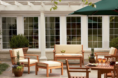 Mid-sized arts and crafts backyard stone patio kitchen photo in Austin with a pergola