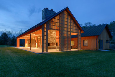 Inspiration for a large modern yellow two-story wood exterior home remodel in Other with a metal roof
